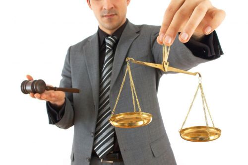 a man holding a scale of justice and a judge's gavel